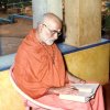 Swamiji reading in the Old Ashram verandah